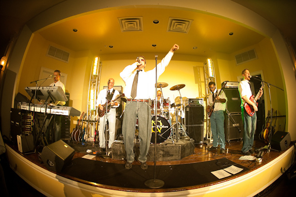 fish eye view of the wedding musicians on stage at the reception - photo by Houston based wedding photographer Adam Nyholt 